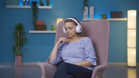 Woman-listening-to-music-with-headphones-is-unhappy-and-sad.
